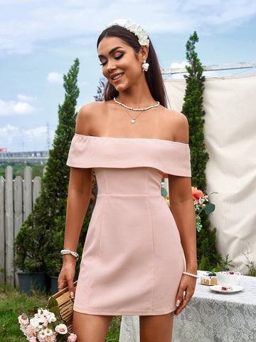 Woman wearing a pink off-the-shoulder mini dress outdoors