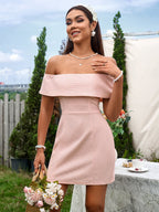 Woman in a pink off-the-shoulder dress holding a basket of flowers