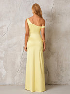 Back view of a woman in a pale yellow satin one-shoulder floor-length gown