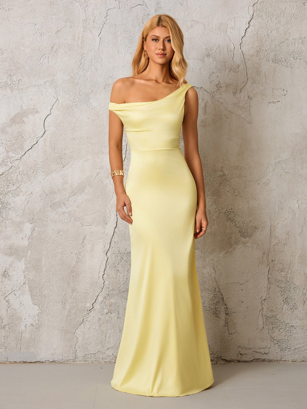 Model wearing a pale yellow satin one-shoulder floor-length gown
