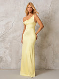 Front view of a woman in a pale yellow satin one-shoulder floor-length gown
