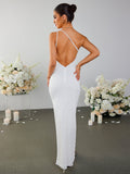 Back view of a woman in a white one-shoulder textured column gown with an open back.