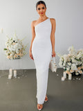 Woman holding a white handbag and wearing a white one-shoulder textured column gown.