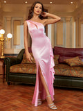 Full-length shot of a woman in a pink satin one-shoulder evening dress with a slit.