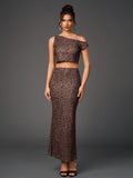 Full-body shot of a woman in a brown leopard print sheer mesh two-piece ensemble, including a one-shoulder cropped top and a floor-length skirt.