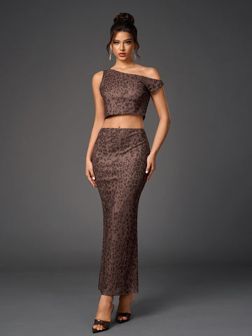Woman wearing a brown leopard print sheer mesh two-piece set with a cropped asymmetrical one-shoulder top and a long fitted skirt.