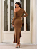 Back view of a woman in a brown one-shoulder long sleeve dress with ruching and a ruffle hem.
