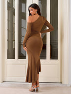 Back view of a woman in a brown one-shoulder long sleeve dress with ruching and a ruffle hem.