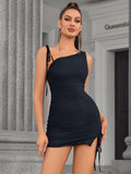 Woman posing in a black one-shoulder ruched mini dress with side slit