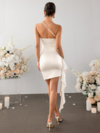 Back view of a cream one-shoulder satin sheath dress with draped detailing.