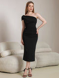 Woman wearing a black one-shoulder ruched sheath dress