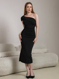 Full-length shot of a woman in a black ruched one-shoulder dress