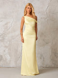 Front view of a woman in a pale yellow satin one-shoulder floor-length column dress with draping and ruching
