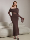 Woman wearing a long brown off-the-shoulder dress with ruched detailing and sheer paneling