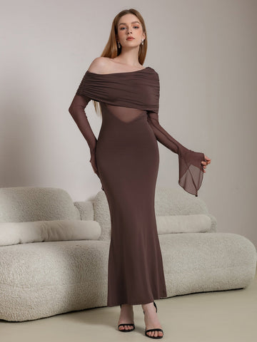Woman wearing a long brown off-the-shoulder dress with ruched detailing and sheer paneling