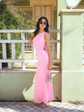 Full length shot of a woman in a pink one-shoulder ruched maxi dress.