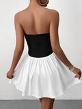 Woman wearing a black strapless bodice with a white gathered skirt, back view
