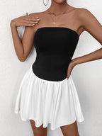 Close-up of a woman wearing a black strapless bodice with a white gathered skirt