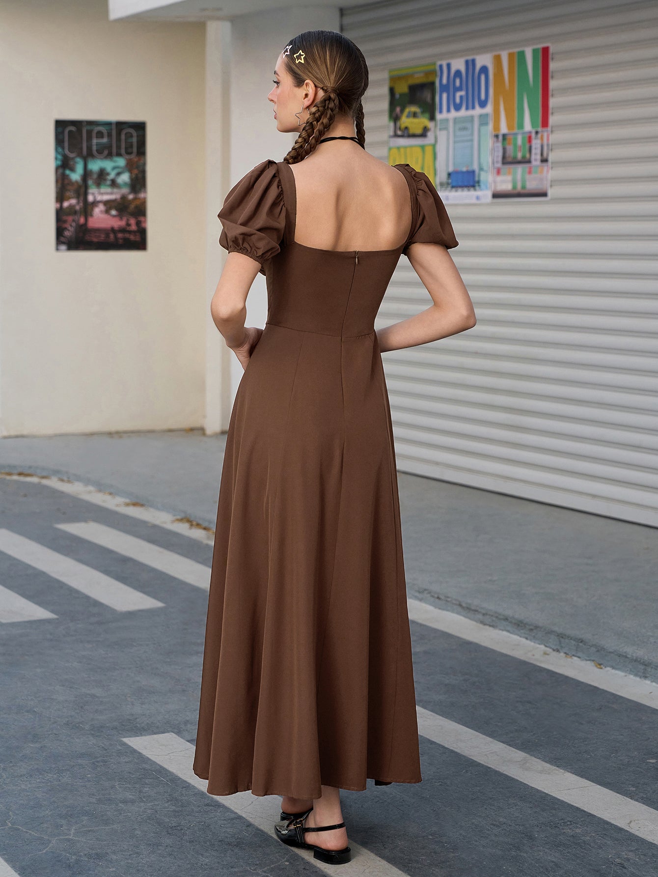 Back view of a woman in a brown puff sleeve midi dress