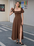 Woman adjusting her dress in a brown puff sleeve midi dress with a square neckline