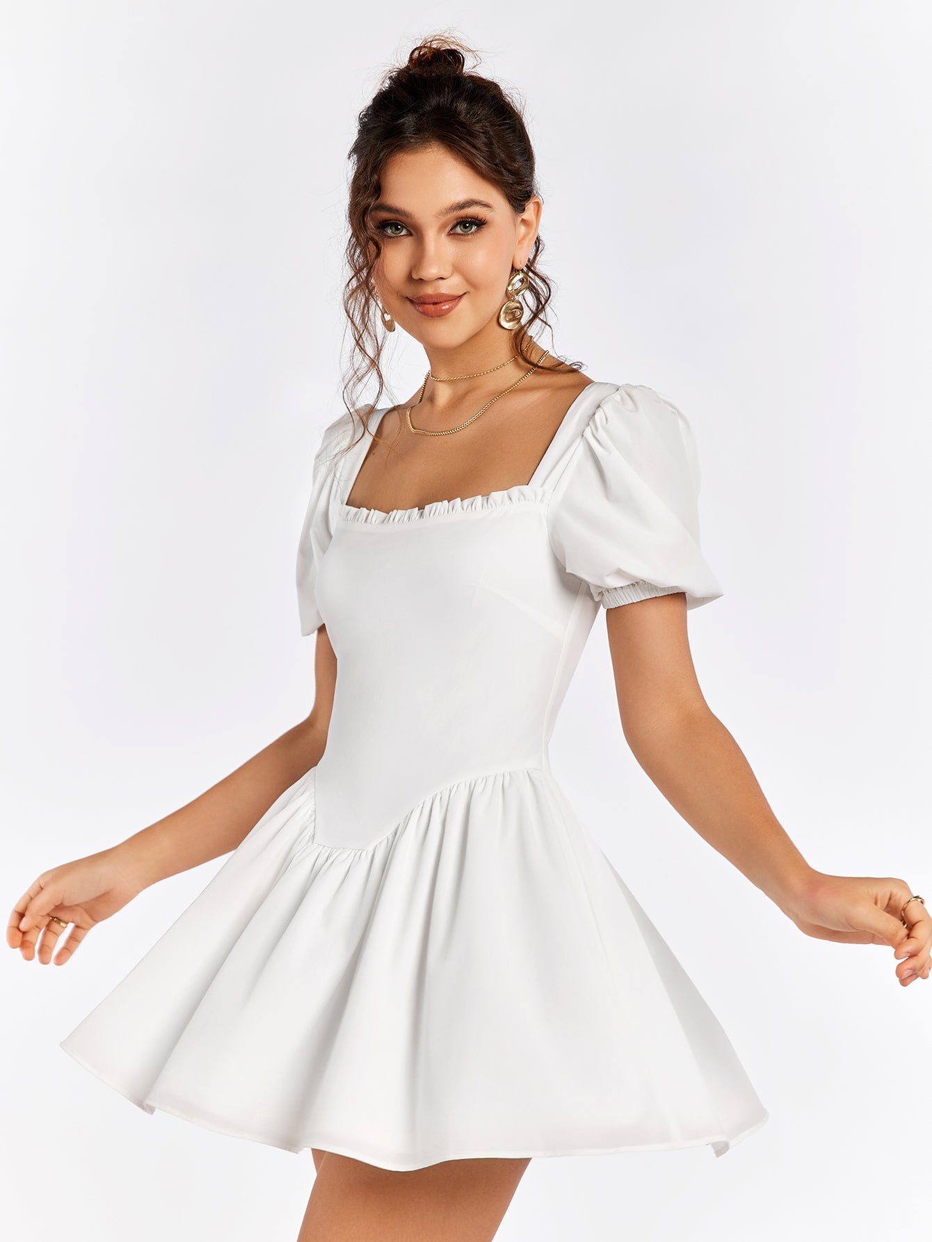 Woman twirling in a white short dress with puff sleeves and a square neckline