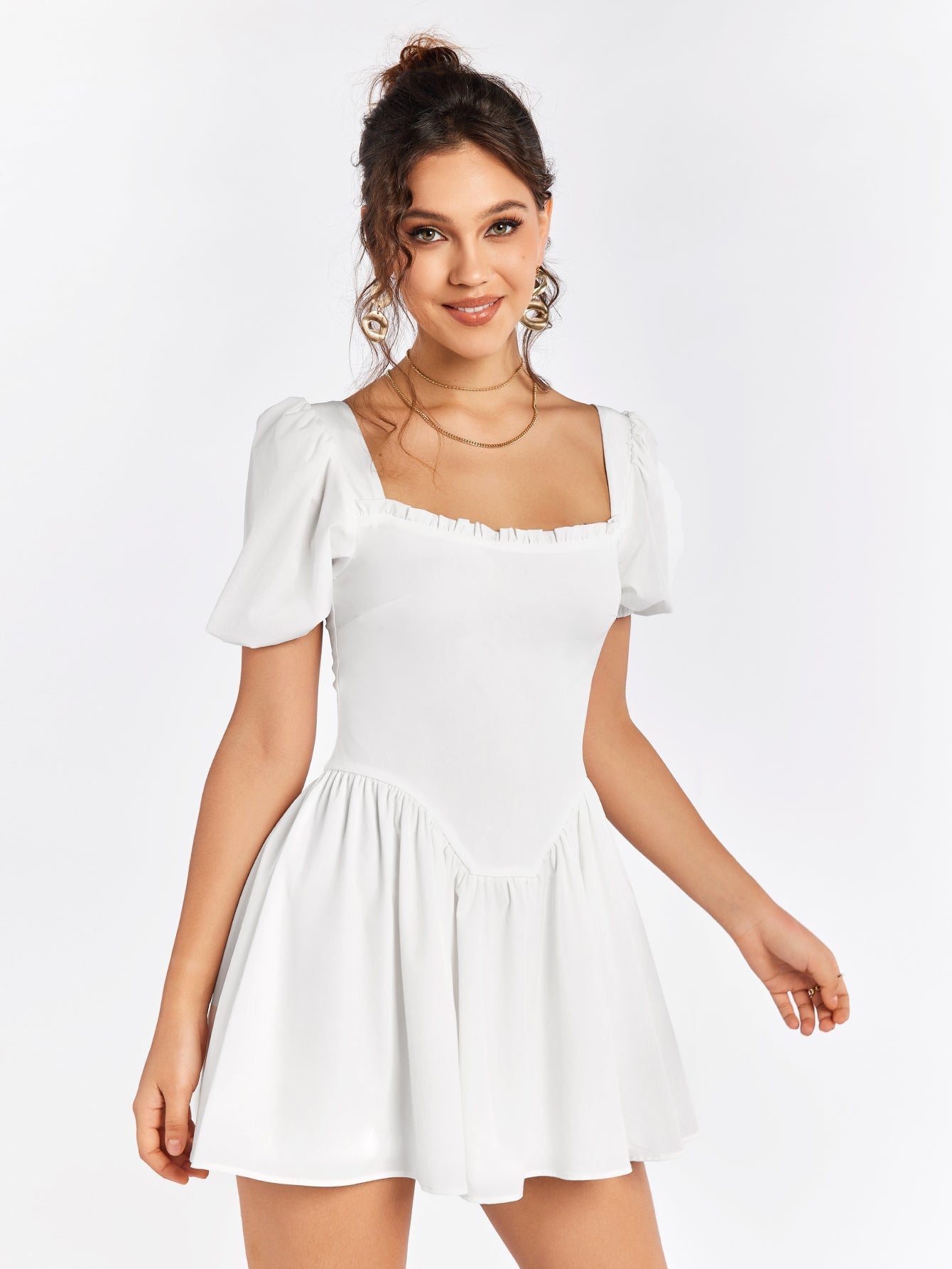 Woman smiling and wearing a white short dress with puff sleeves and a square neckline