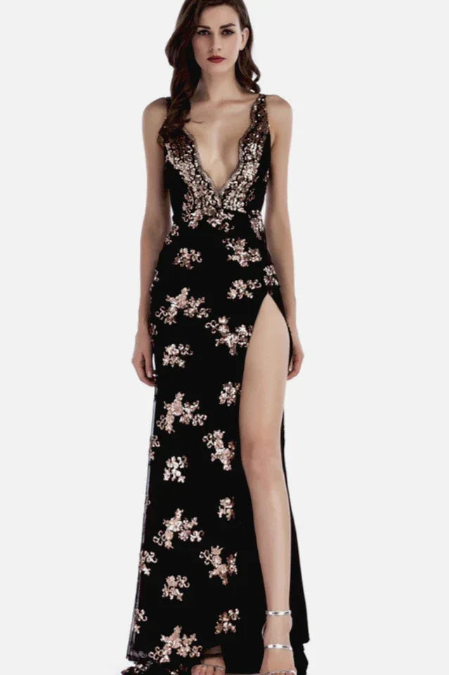Woman in a black sequined V-neck, sleeveless evening gown with a high leg slit and open back.