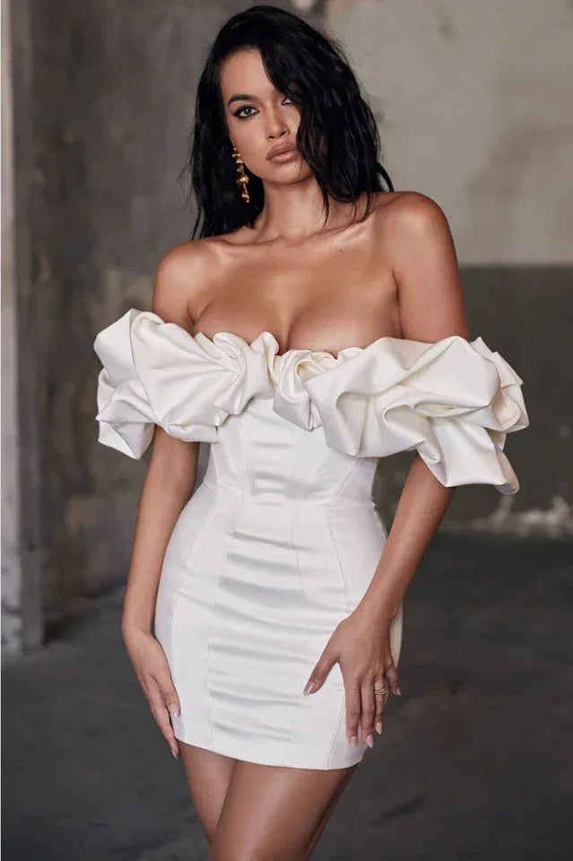 Woman in a white off-the-shoulder mini dress with ruffle sleeves and a corset bodice. Main image