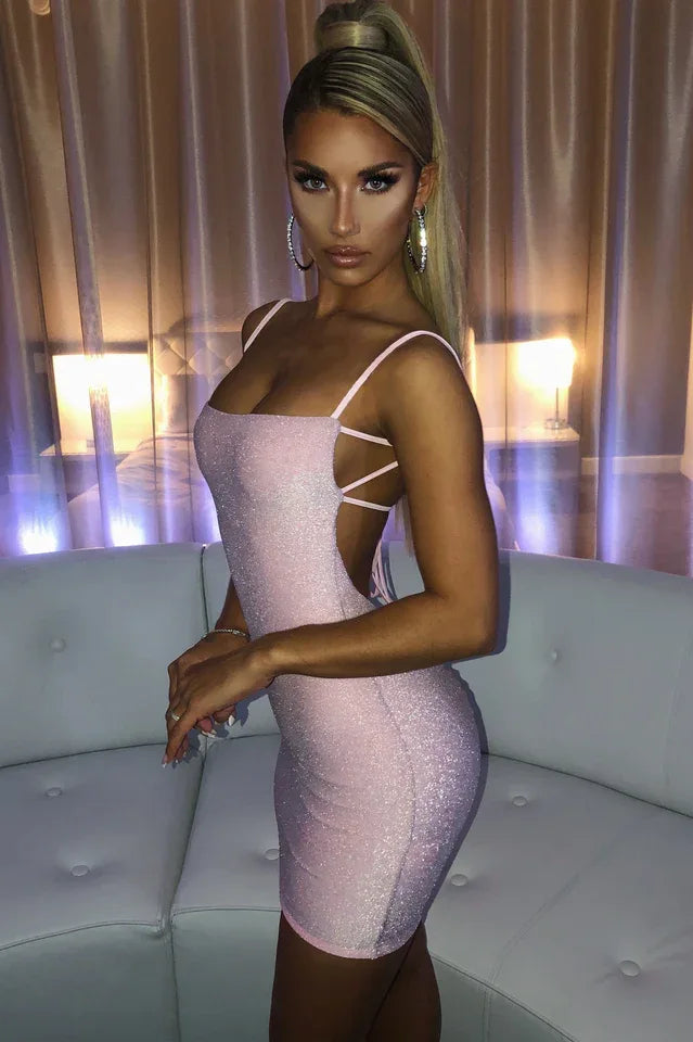 woman wearing a pink sparkling bodycon mini dress with spaghetti straps