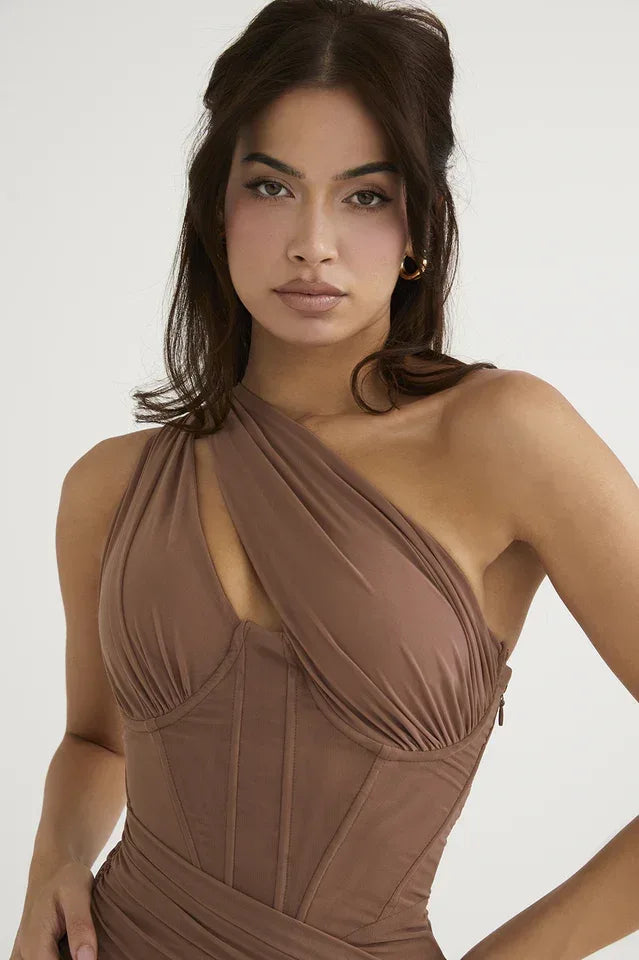 Close-up of the neckline and bodice of a brown asymmetrical one-shoulder ruched bodycon midi dress