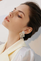 Side profile of a woman adorned with glamorous chandelier earrings.