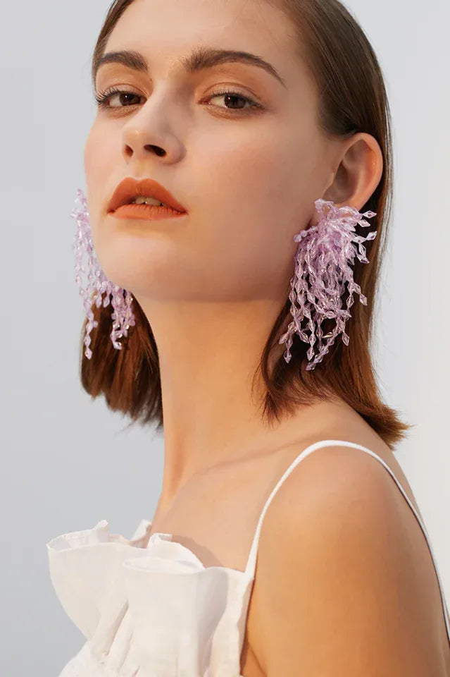 Side profile of model with lavender beaded earrings