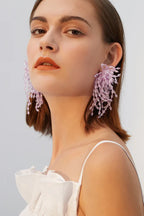 Side profile of model with lavender beaded earrings