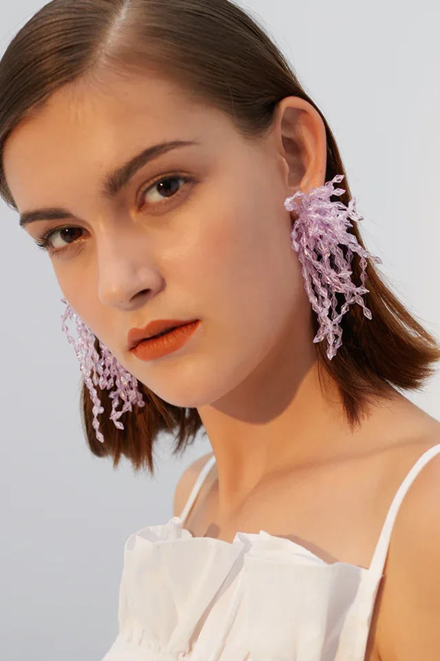 Model wearing lavender beaded chandelier earrings with dangling strands Main image