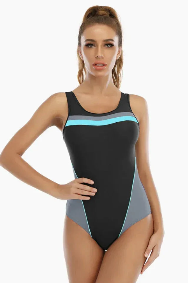 Woman wearing a black one-piece swimsuit with grey and light blue accents Main image