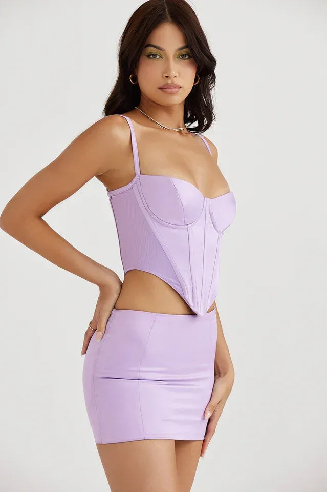 Side profile of a woman showcasing the fitted silhouette of the lavender faux leather corset top.