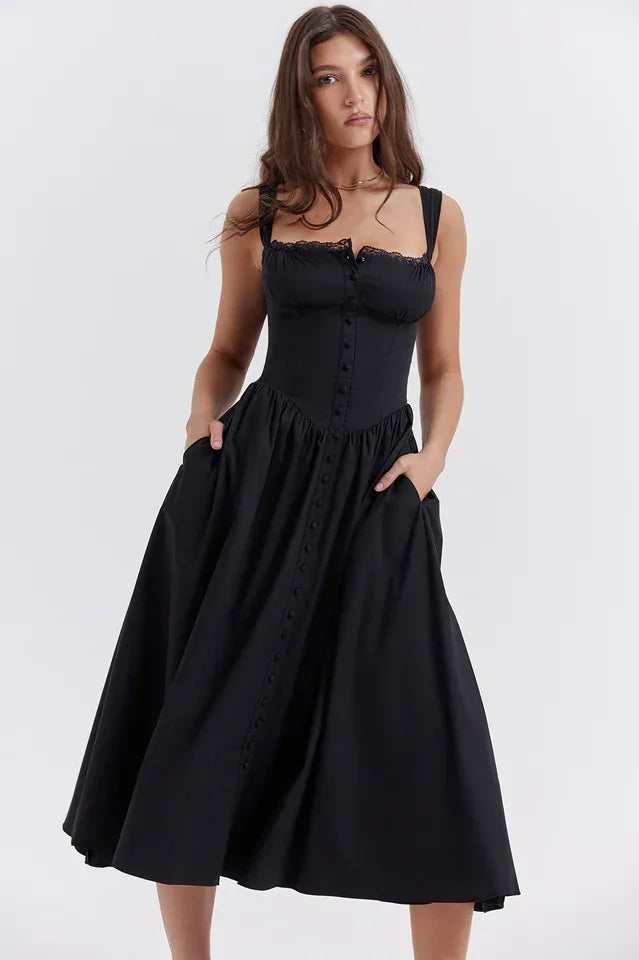 Woman showing the pockets on a black button-front midi dress