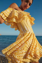 Close-up of the ruffled neckline of a yellow Bardot dress