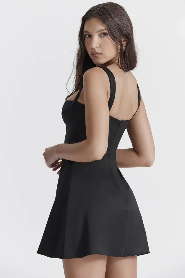 Full front view of a woman in a black Duchess Satin mini dress