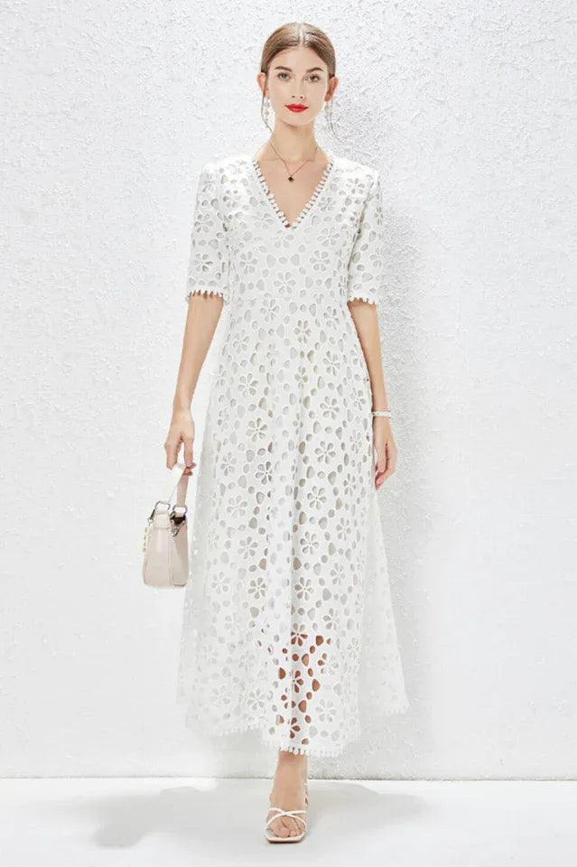 Woman wearing a white lace maxi dress with V-neckline and half sleeves Main image