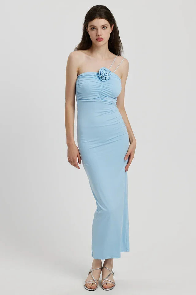 Woman wearing a light blue ruched one-shoulder maxi dress with a floral applique Main image