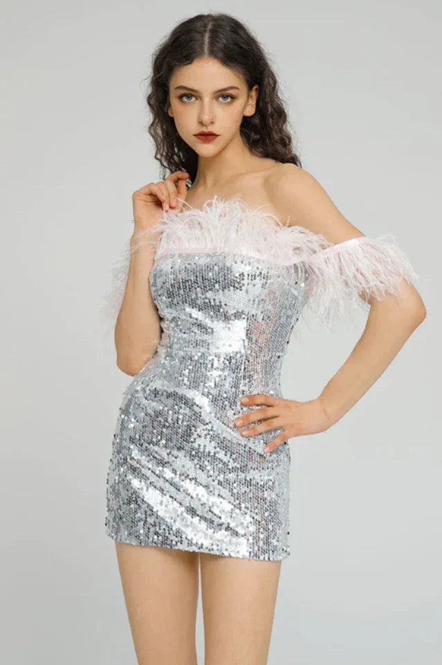 woman in silver sequin off-the-shoulder dress with pink feather trim Main image