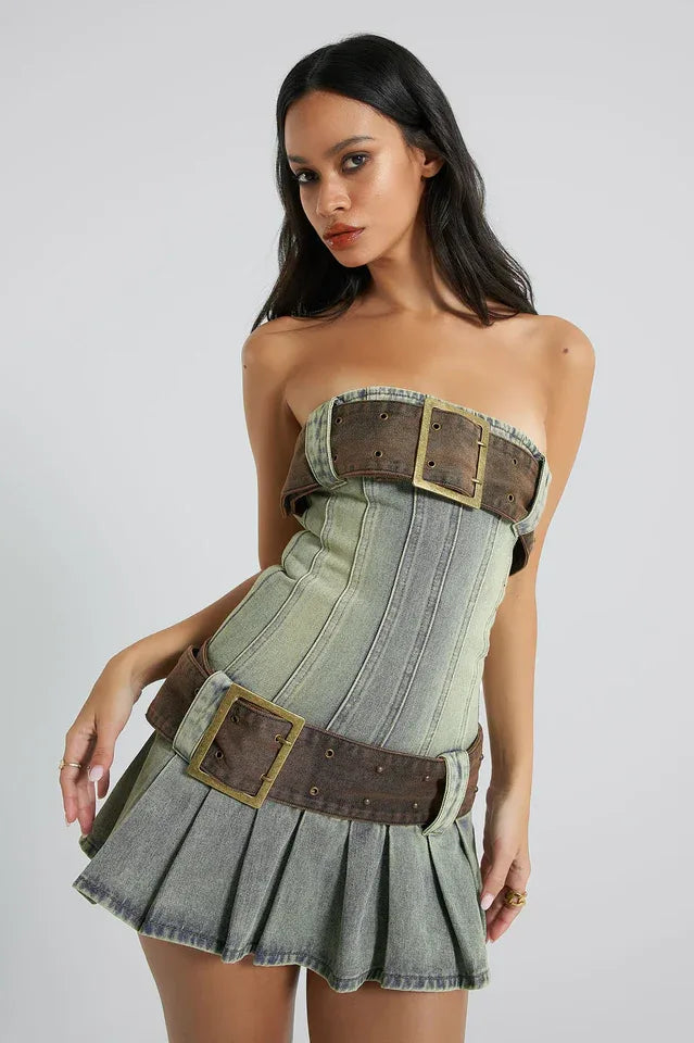 Woman wearing a distressed denim kilt mini dress with a large buckle belt Main image
