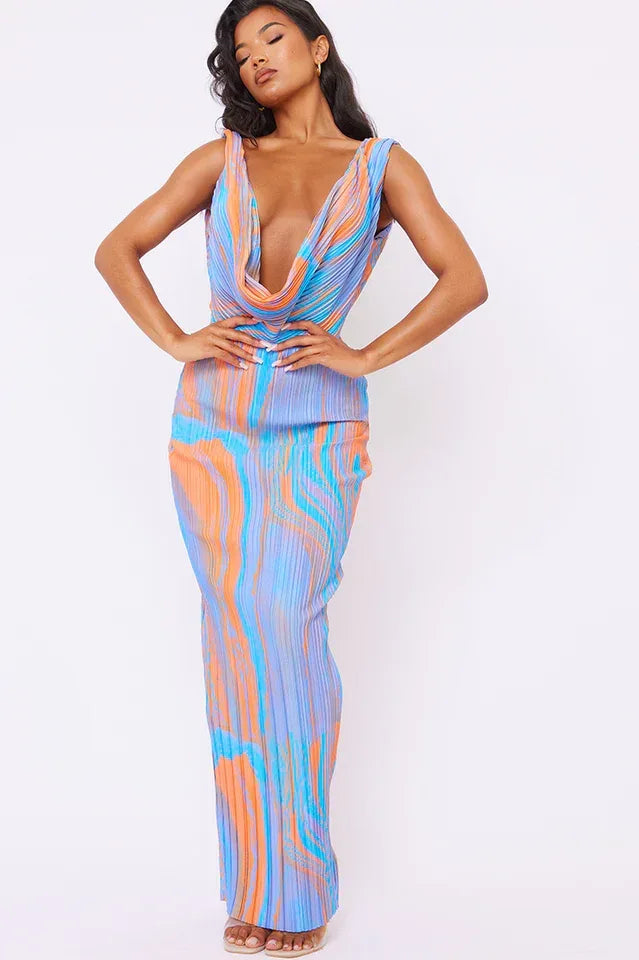 Woman wearing a blue, orange, and white tie-dye print maxi dress with a deep V-neck and sleeveless design.