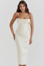 Model in a white satin strapless corset midi dress with intricate beaded embellishments along the neckline.