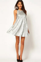 Woman modeling a silver sequined A-line mini dress with a round neckline