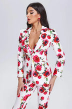 Close-up of a woman wearing a white blazer with a red floral print.