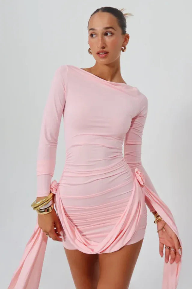 Woman wearing a pink mini dress with a red floral print, featuring a halter neckline and a cutout detail. Main image