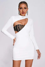Woman wearing a white long-sleeve bodycon mini dress with a cutout detail and a black lace-trimmed contrast panel insert.