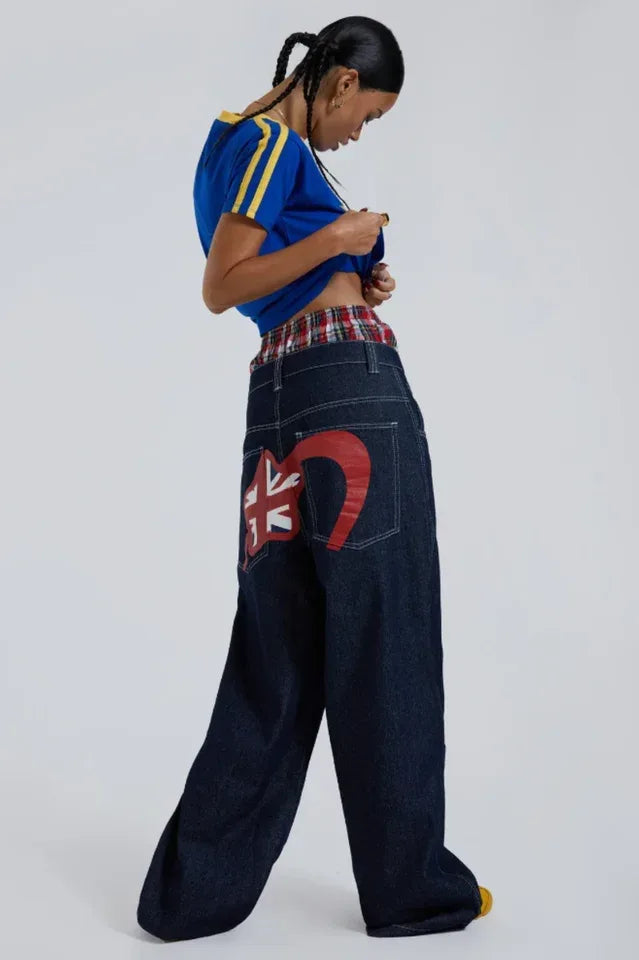 Model wearing dark wash wide leg jeans with graphic print on back pocket and blue t-shirt Main image